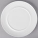 A white 10 Strawberry Street Ricard porcelain dinner plate with a white rim on a gray surface.