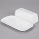 A white rectangular porcelain butter dish with a lid.