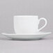 A 10 Strawberry Street white porcelain espresso cup and saucer with a white surface.