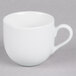 A 10 Strawberry Street white porcelain espresso cup with saucer on a gray surface.