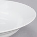 A close-up of a 10 Strawberry Street Classic White porcelain soup bowl with a rim.