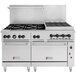 A Wolf stainless steel commercial range with double ovens, 6 burners, and a charbroiler.