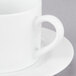 A close-up of a 10 Strawberry Street white porcelain cup and saucer.