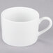 A 10 Strawberry Street white porcelain cup and saucer on a gray surface.