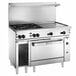 A large stainless steel Wolf commercial range with two burners, a griddle, and a convection oven.