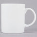 A close up of a 10 Strawberry Street white porcelain mug with a handle.