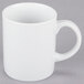 A close-up of a 10 Strawberry Street white porcelain mug with a handle.