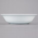 A 10 Strawberry Street Classic White porcelain vegetable bowl on a gray surface.