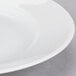 A close-up of a 10 Strawberry Street Classic White porcelain bread and butter plate with a white rim.