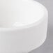 A close-up of a 10 Strawberry Street white porcelain ramekin.