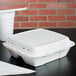 A white Dart foam take out container with 3 compartments and a perforated lid.