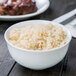 A 10 Strawberry Street Classic White porcelain oval rice bowl filled with rice on a table.