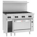 A large stainless steel Wolf commercial range with 8 burners and a convection oven.