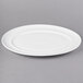A white oval porcelain platter with a rim.