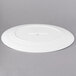 A white porcelain oval platter with a small circle on the edge.