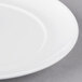A close-up of a 10 Strawberry Street white porcelain bread and butter plate with a white rim.