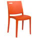 An orange Grosfillex stacking resin chair.
