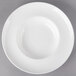 A white 10 Strawberry Street Ricard porcelain pasta bowl on a gray surface.