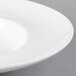 A close up of a 10 Strawberry Street white porcelain pasta bowl with a white rim.