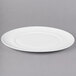A white oval porcelain platter with a rim.