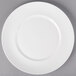 A 10 Strawberry Street white porcelain luncheon plate with a white rim on a gray surface.