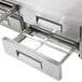 A stainless steel Avantco refrigeration pan divider bar in a kitchen drawer.