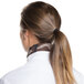 A woman wearing an Intedge camouflage chef neckerchief with a ponytail.