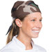 A woman wearing an Intedge camouflage chef bandana in a professional kitchen.