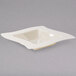 A white square bowl with a wavy edge.