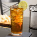 A Libbey Puebla beverage glass of iced tea with lime and ice.