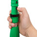 A hand holding a Unger green and black telescopic pole.