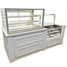 A white countertop with a Federal Industries Italian Series glass bakery display case.