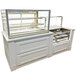 A white counter with a Federal Industries Italian Series Countertop Dry Bakery Display Case on top.