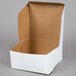 A white bakery box with a brown lid.