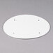 A white circular plastic lid with holes.