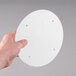 A person holding a white circular Solo vented lid.