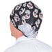 A person wearing a black Headsweats bandana with a skull design.