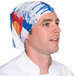 A man wearing a Headsweats Colorado Ultra Band head wrap with a blue and red bandana pattern.