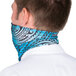 A man wearing a blue and black tribal patterned Headsweats bandana on his head.
