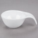 An Arcoroc porcelain spoon with a white bowl and handle.