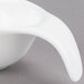 A close-up of an Arcoroc white porcelain spoon with a curved handle.