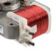 A close up of a coil of red wire with two wires connected to it.