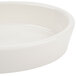 A white Hall China oval baker dish with an ivory finish on a white background.