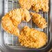 Fried chicken on a Choice footed pan grate.
