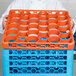 A woman holding a Carlisle orange plastic rack with blue and orange cups.
