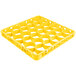 A yellow plastic grid with holes for holding small items.