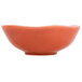 An Arcoroc orange porcelain bowl with a red rim.