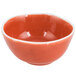 An Arcoroc orange porcelain bowl with a white edge.