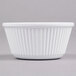 A close-up of a white fluted Thunder Group ramekin.