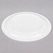 A Carlisle white polycarbonate plate with a narrow rim on a gray surface.